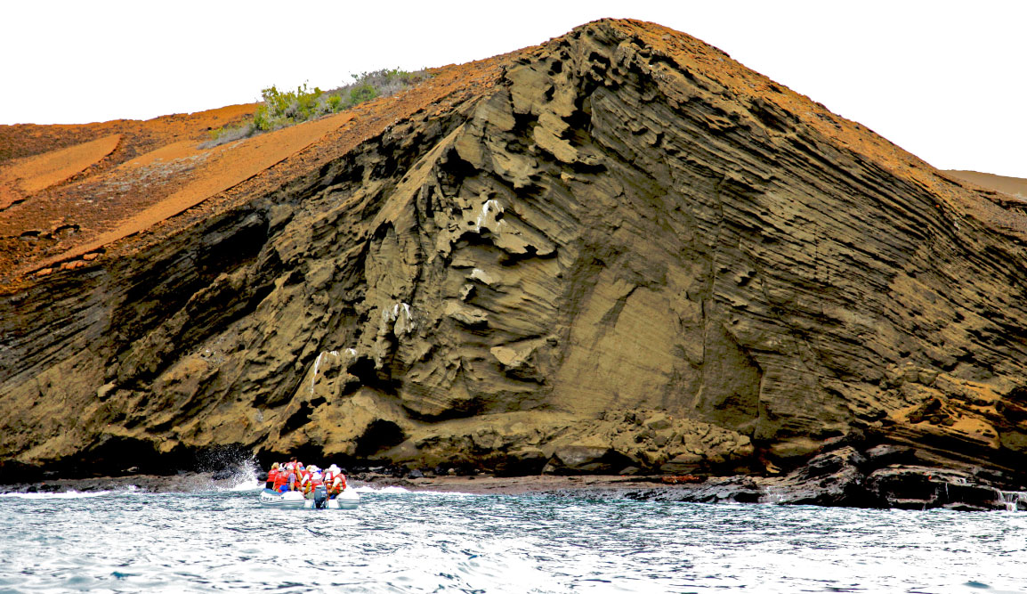 Bartolome in Galapagos Islands landscape with tourist in panga