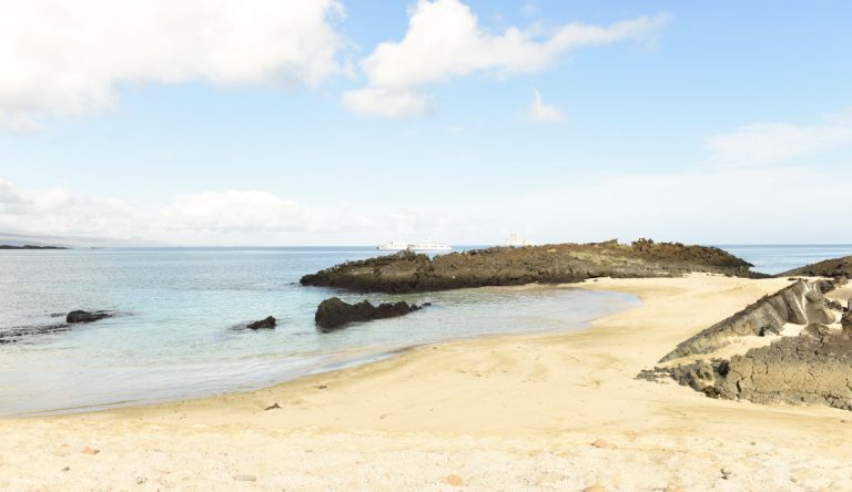 Cerro Brujo - San Cristobal in Galapagos Islands, view of the beach landscape with a blue sky