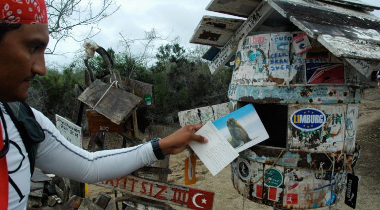 Post Office - Floreana Island in the Galapagos, tourist taking letters and postals