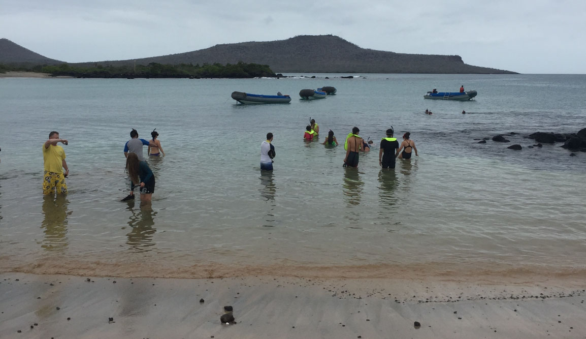 Post Office - Floreana Island in the Galapagos, view of a beach with tourist